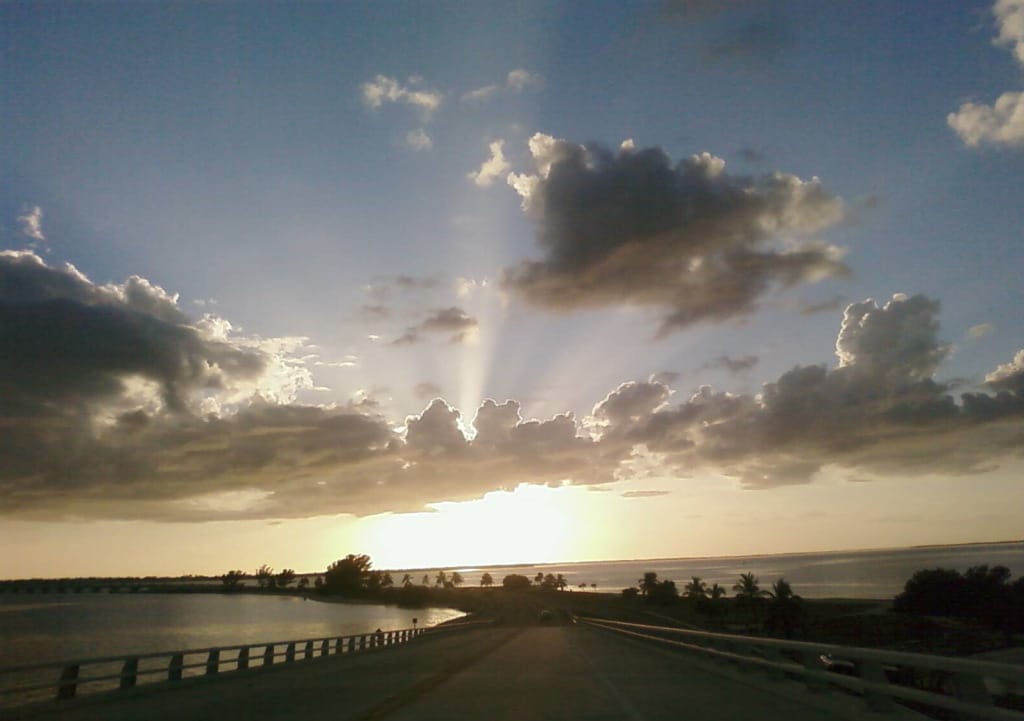 Sanibel Causeway Surplus, Sunrise on the Causeway - Sanibel Island by Michele Lorito-Chase, Via Creative Commons.