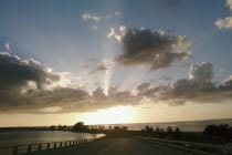 Sanibel Causeway Surplus, Sunrise on the Causeway - Sanibel Island by Michele Lorito-Chase, Via Creative Commons.