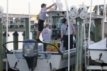Members of Sanibel Fire & Rescue clean their vessel after transporting a body that was found about 400 yards off the Sanibel causeway on Friday. (Photo: Jack Hardman/The News-Press, Jack Hardman/The News-Press)
