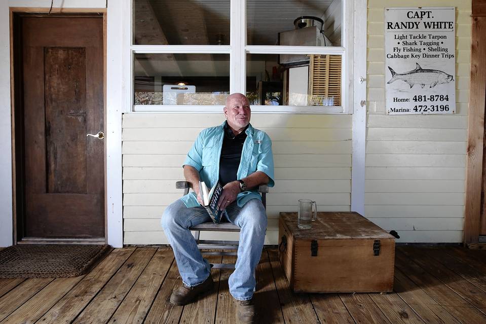 Sanibel Rentals, 4-24-15, Randy Wayne White on the front porch of his Pine Island, Fla., home that he purchased in the late 1980s for about $225,000. PHOTO- ALEXIA FODERE FOR THE WALL STREET JOURNAL.