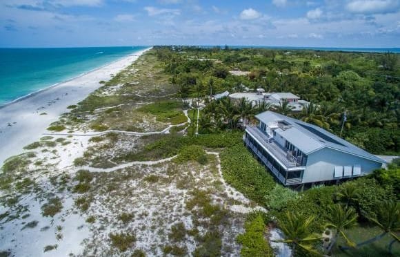 16500 Captiva Dr Captiva 33924 - A Majestic Captiva Island Beachfront Estate. A private and beautifully landscaped driveway opens up to over one acre of a pristine and inviting setting. Situated due west this unique and special piece of paradise offers 5 bedrooms/5 baths w/2 separate guest suites and an awe inspiring raised swimming pool that flows within the surroundings of the home is nothing less than spectacular. Courtesy Of Royal Shell.